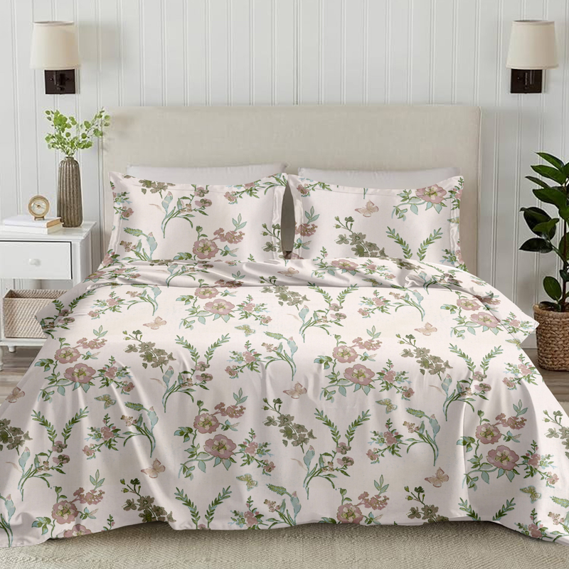 Floral bedding set on a bed in a bedroom with lamps and plants.