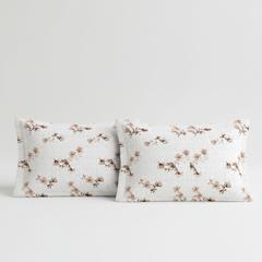 Two floral-patterned pillows on a light gray background