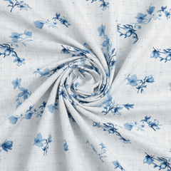 Rolled-up fabric with blue floral pattern on a white background