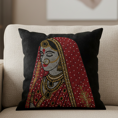 Decorative pillow with a traditional design on a beige sofa in a living room setting.
