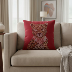 Red pillow with a leopard design on a beige sofa in a living room.