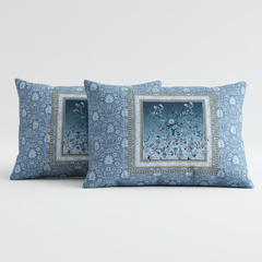 Two blue patterned pillows on a white background