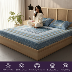 Woman sitting on a bed with a blue patterned mattress cover, holding a cup.