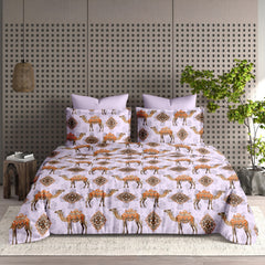 Bedding set with camel pattern on a bed in a room with a decorative wall and plant.
