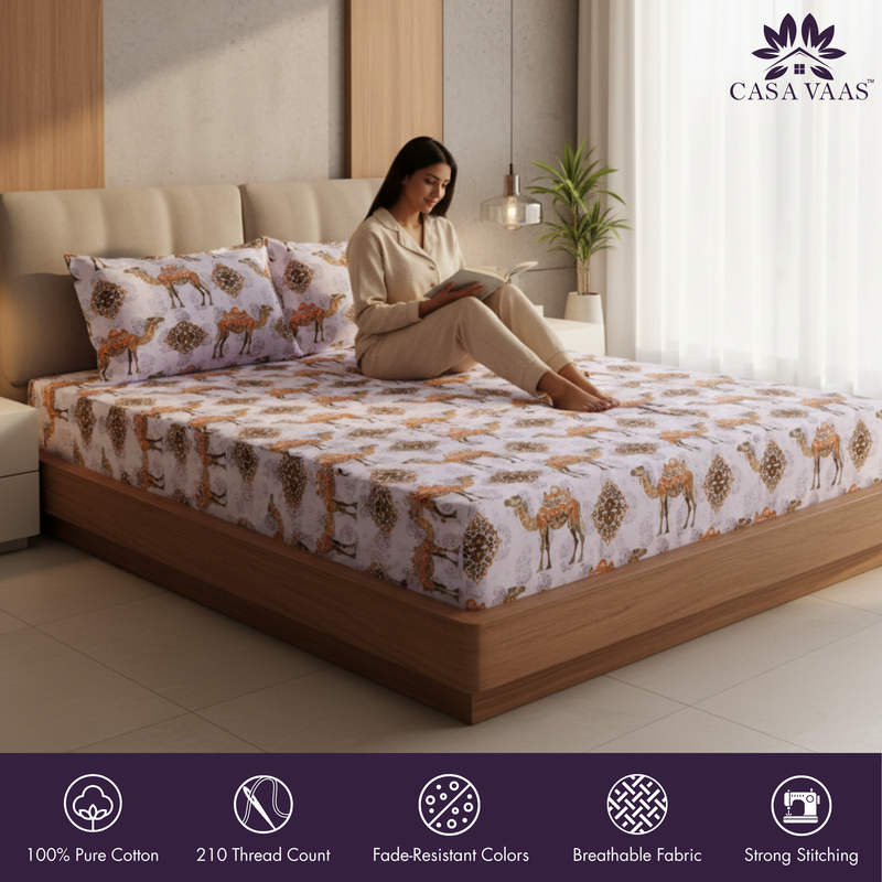 Woman reading a book on a bed with a patterned bedspread, Casa Vaas brand visible