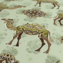 Patterned fabric with deer design on a light green background