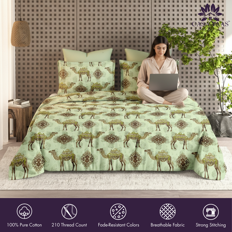 Woman using a laptop on a bed with a camel patterned comforter, featuring the brand 'Ombre'.