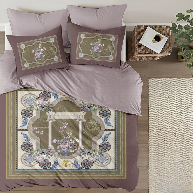 Decorative bedspread with floral patterns on a bed in a bedroom setting.