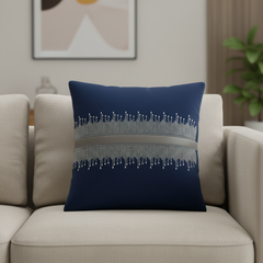 Navy blue pillow with decorative pattern on a beige sofa