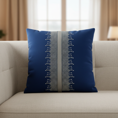Blue pillow with decorative pattern on a beige sofa