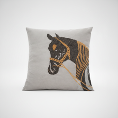 Gray pillow with a horse design on a white background