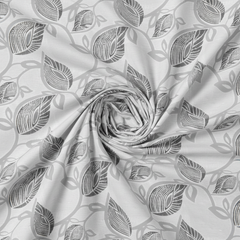 Roll of fabric with leaf pattern on a white background