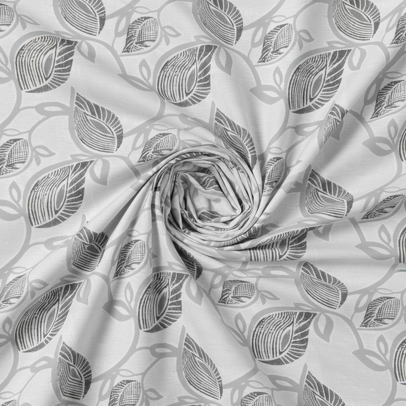 Roll of fabric with leaf pattern on a white background