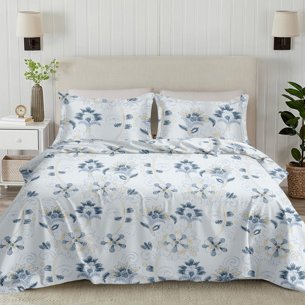 Floral bedding set on a bed in a bedroom with lamps and plants.